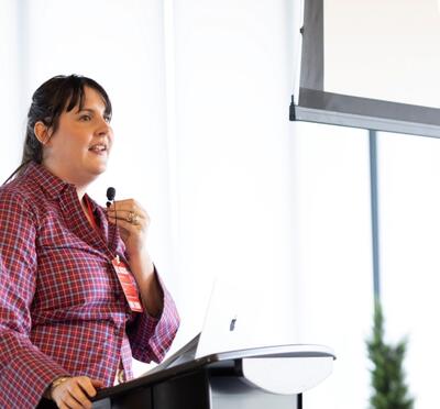 Mary Weedman Lorish speaking behind a podium