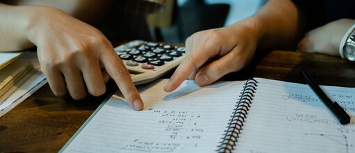 Hands pointing at paper with numbers