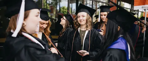 Students smiling at commencement