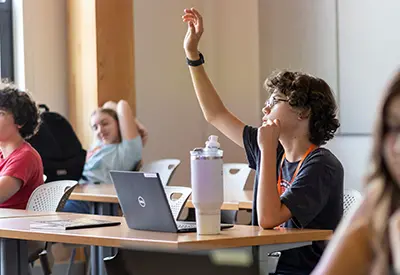 Student Raising Hand in a classroom 