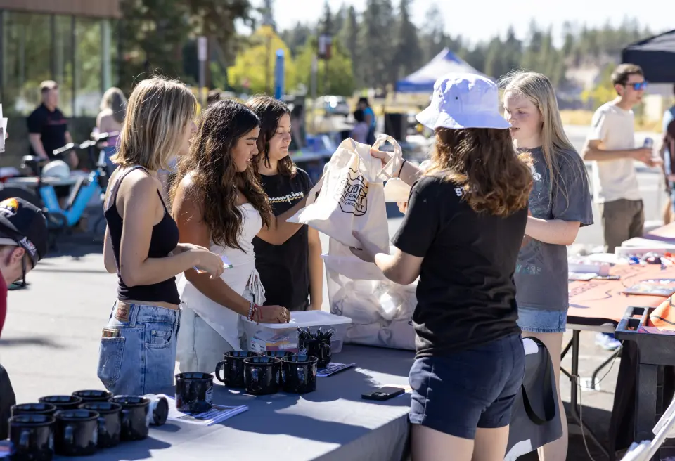 Students meeting at outdoor resource fair.