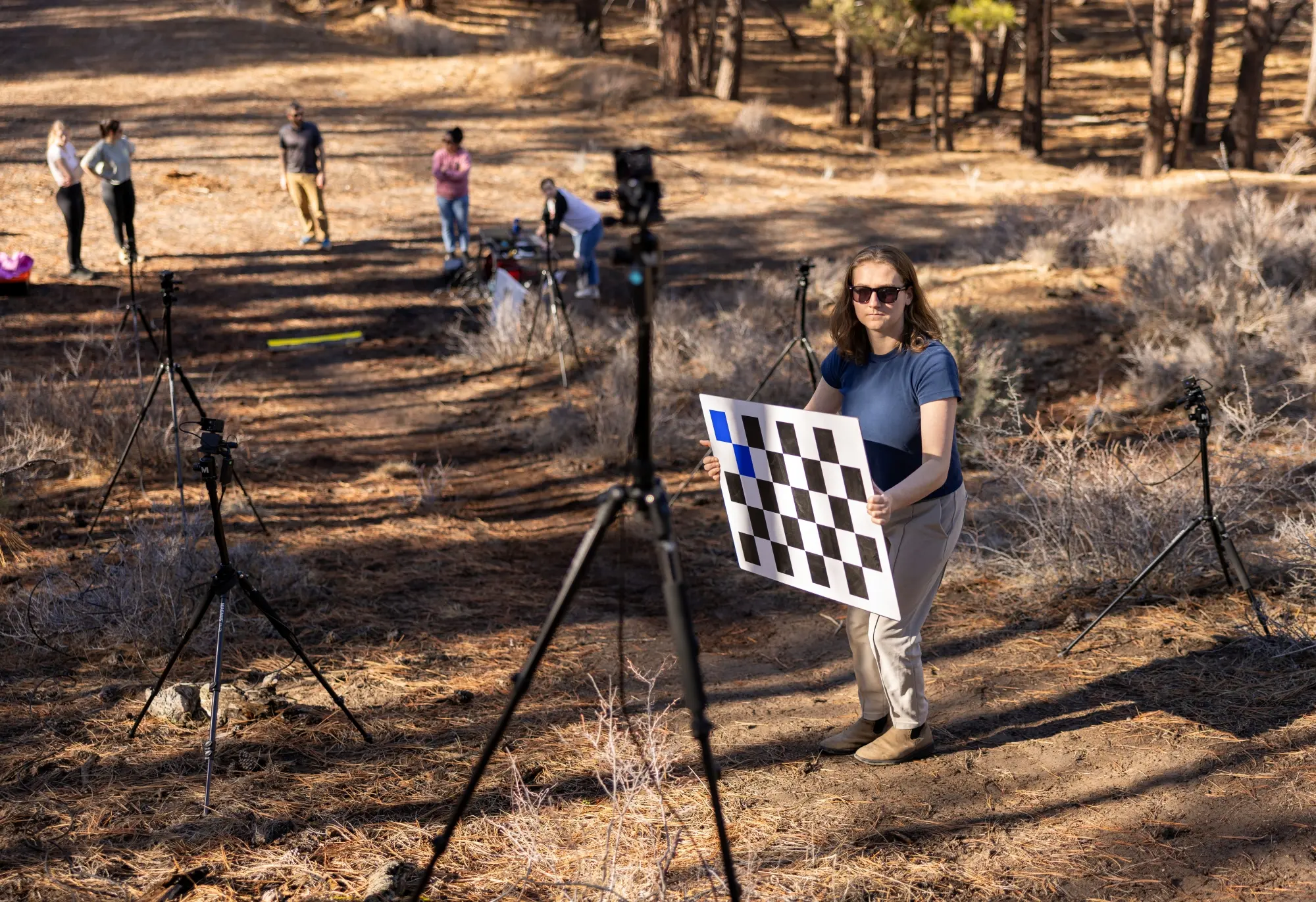 People on track holding a checkerboard