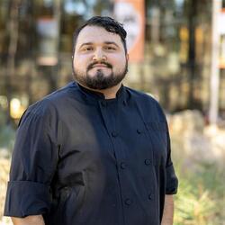 Jose Side standing on campus for a headshot.