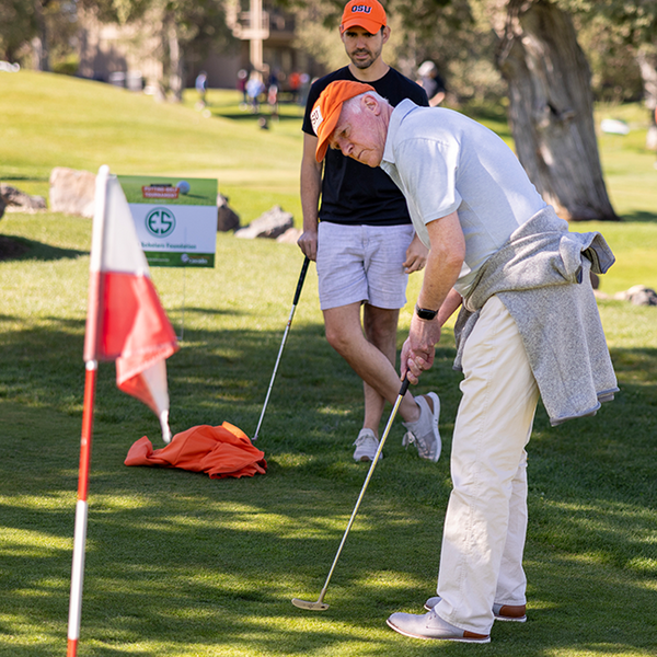 Chancellor and Dean Sherm Bloomer putting.